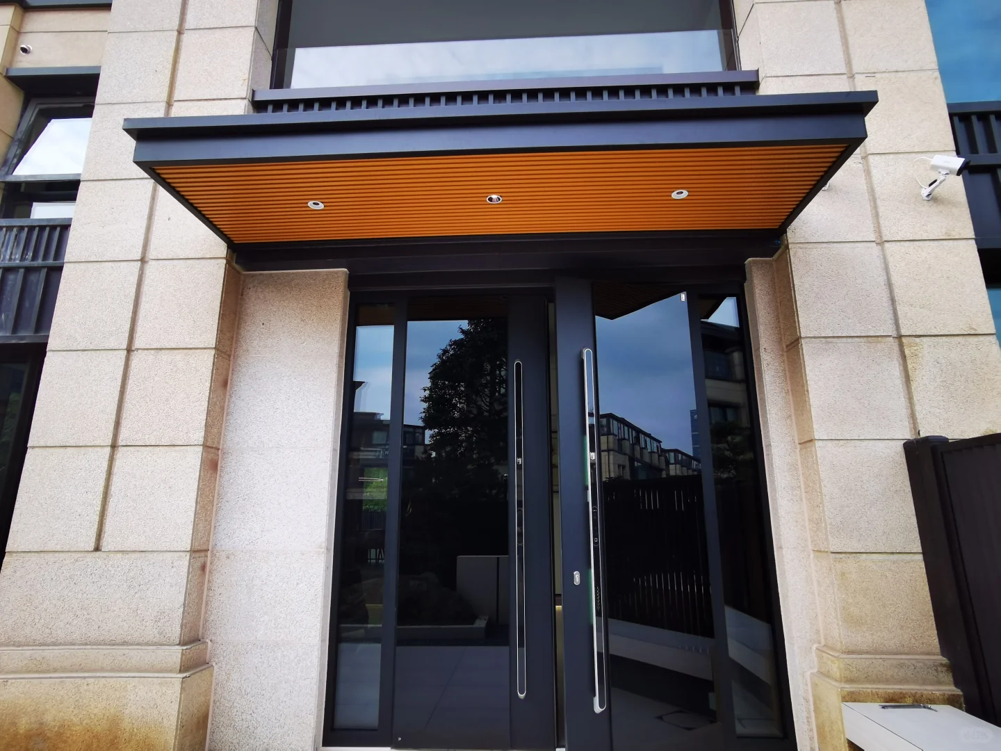Fixed solid panel aluminum awning installed above a luxury villa facade entrance